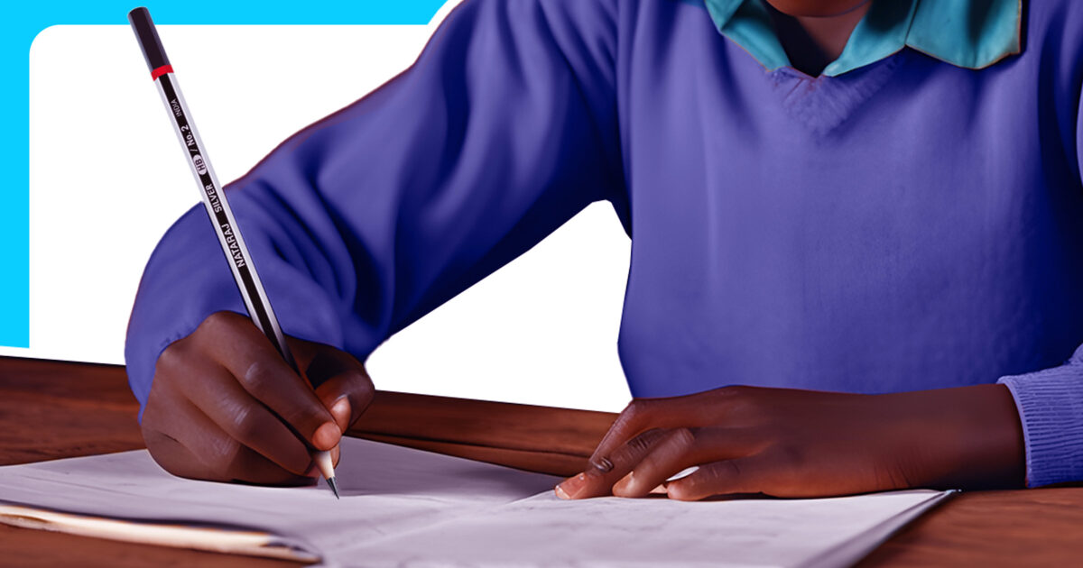 Young african boy in uniform writing on a piece of paper with a Nataraj Pencil